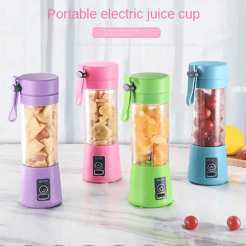 Hand holding mini juicer blender filled with fresh fruits