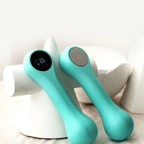 Wireless smart dumbbell resting on yoga mat, used for full-body strength training at home