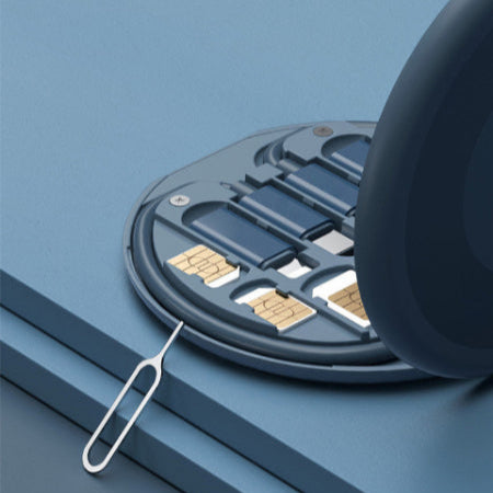 SIM card tray with two SIM cards and a metal eject tool on a blue background