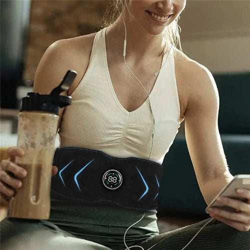  Woman using belly fat belt while drinking protein shake, showing post-workout recovery.