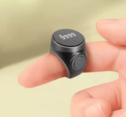 Close-up of digital tasbeeh counter on finger