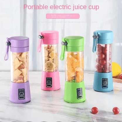 Hand holding mini juicer blender filled with fresh fruits