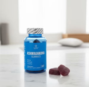 Blue bottle of Ashwagandha gummies on a marble surface with a white background