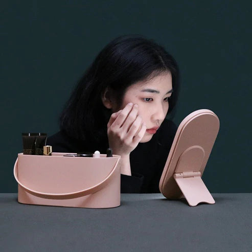 LED Makeup Mirror Box – Portable Storage Organizer in pink with built-in vanity lights, shown in use for makeup application on a tabletop.