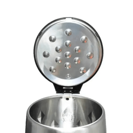 Metallic salt shaker with a textured top on a white background