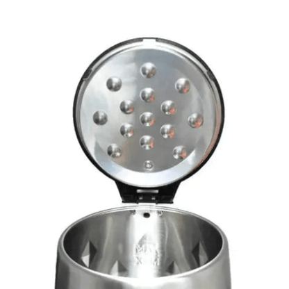 Metallic salt shaker with a textured top on a white background
