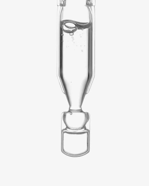 Close-up of Ultra-Hydrating Hyaluronic Acid Face Serum in a clear glass ampoule, showcasing its purity and lightweight texture for radiant skin.