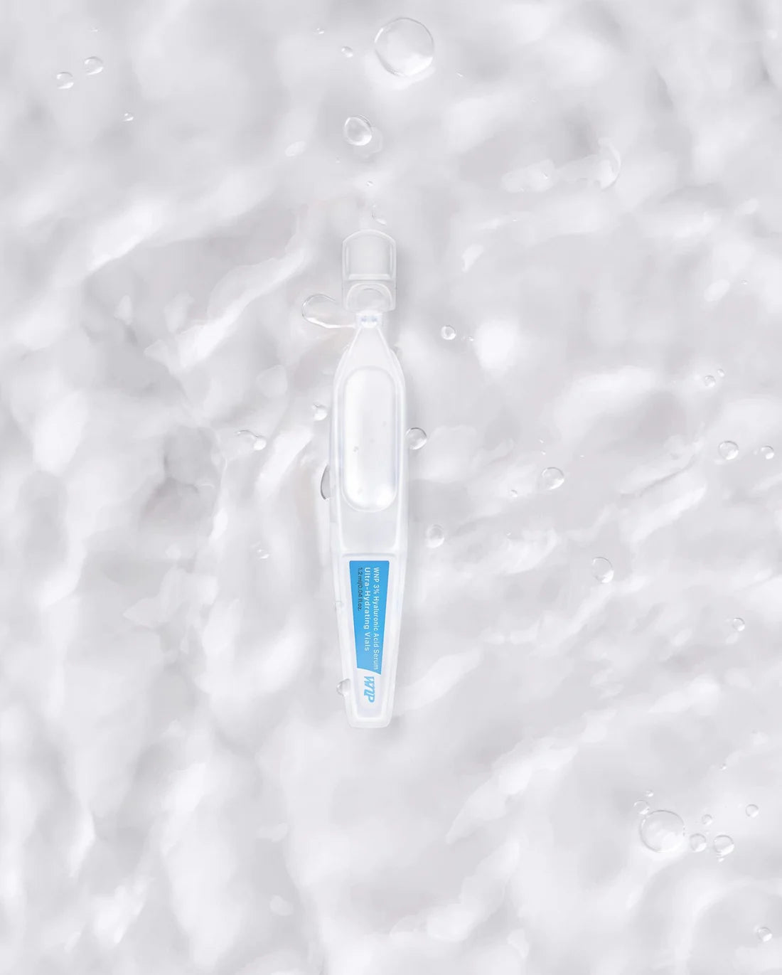 Ultra-Hydrating Hyaluronic Acid Face Serum ampoule on a water-textured background. Ideal for boosting radiance and deep skin hydration.