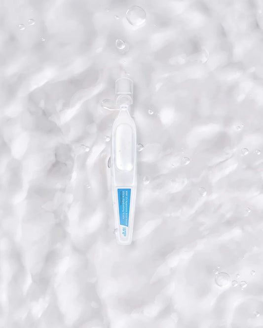 Ultra-Hydrating Hyaluronic Acid Face Serum ampoule on a water-textured background. Ideal for boosting radiance and deep skin hydration.