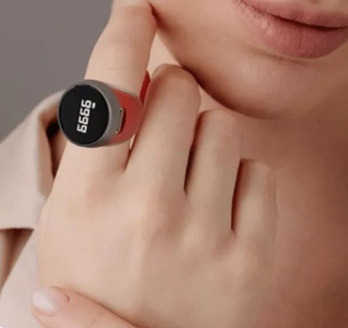 Close-up of a hand wearing a red digital fitness tracker