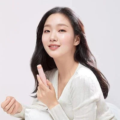 Woman holding a pink product against a white background